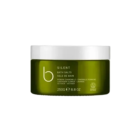 Green jar of Silent bath salts with white lid on a white background